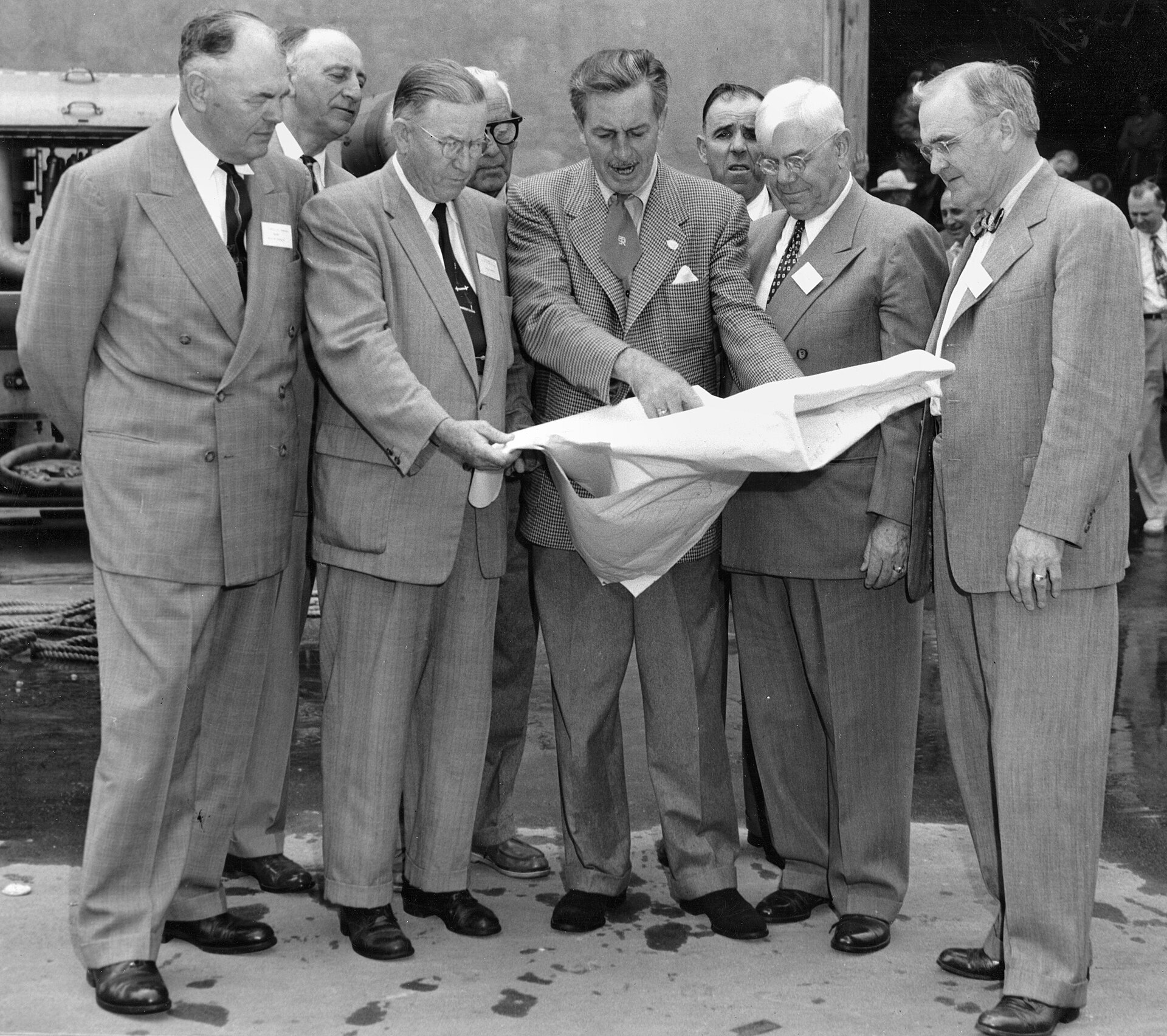 Walt Disney (center) showing Orange County officials plans for Disneyland's layout, December 1954. Source: By Orange County Archives