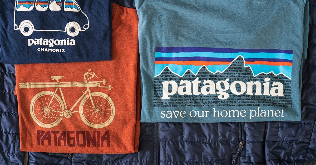 Three Patagonia T-shirts laid out on a quilted jacket, one printed with the line "save our home planet".